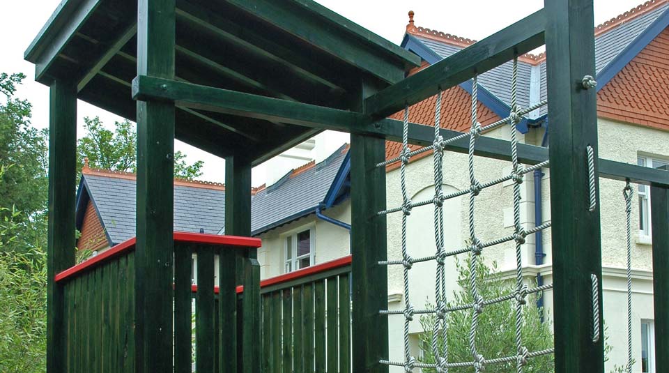 Climbing wall and zipline tower in a Dublin play garden