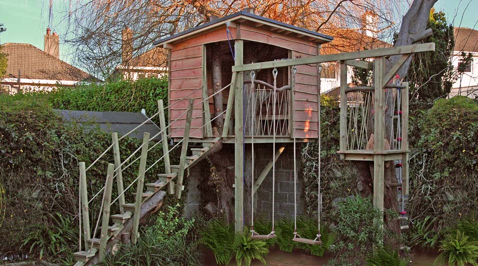 Quirky children’s treehouse design, with crow nest and swings